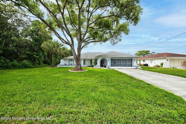 ranch-style house with a garage and a front lawn