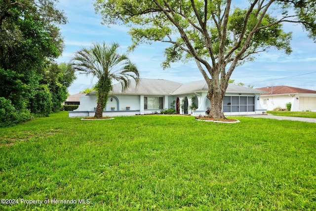 single story home with a garage and a front yard