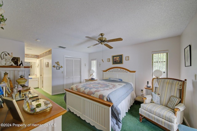 bedroom with ceiling fan, a closet, carpet, and a textured ceiling