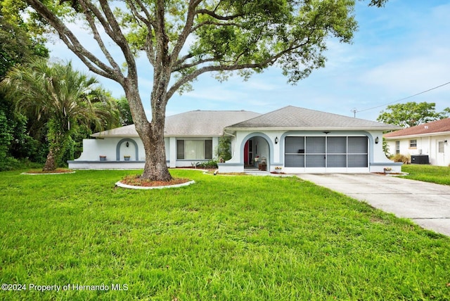 single story home featuring cooling unit and a front yard