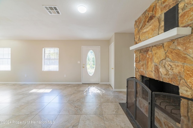 foyer entrance featuring a fireplace