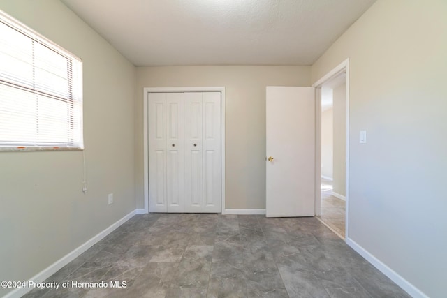 unfurnished bedroom with a closet