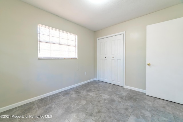 unfurnished bedroom with a closet