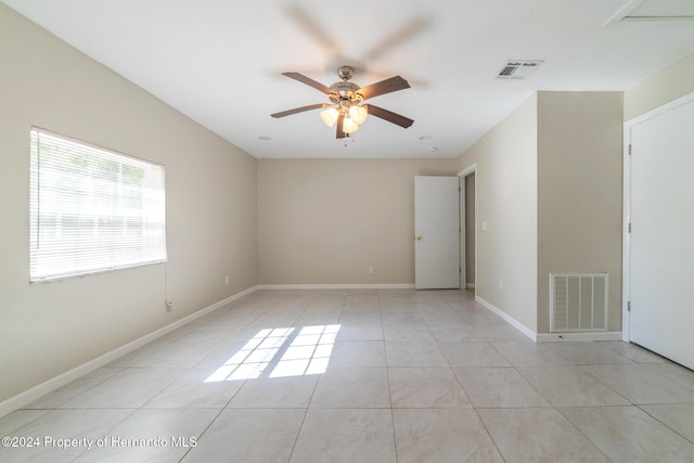 unfurnished room with ceiling fan and light tile patterned flooring