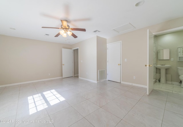 spare room featuring light tile patterned floors, ceiling fan, and sink