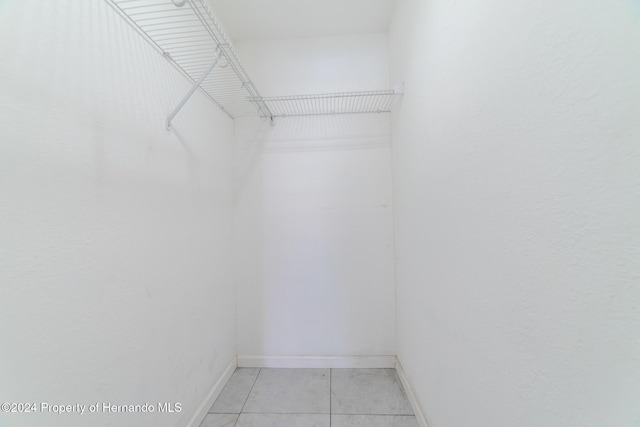 spacious closet with light tile patterned floors