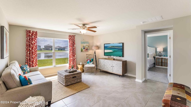 living room with light tile patterned floors and ceiling fan