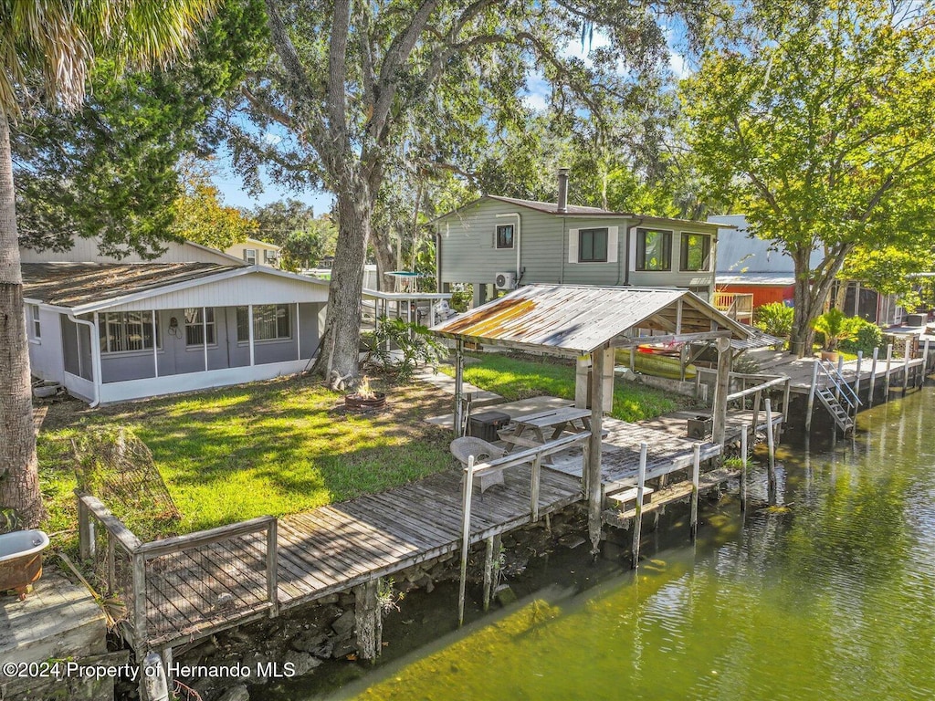 7195 Bethesda Ct, Weeki Wachee, FL 34607 - dock area with a lawn and a water view
