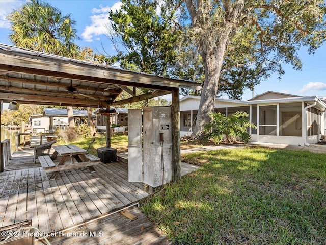 view of yard with a sunroom and a wooden deck