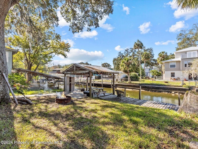 dock area featuring a yard and a water view