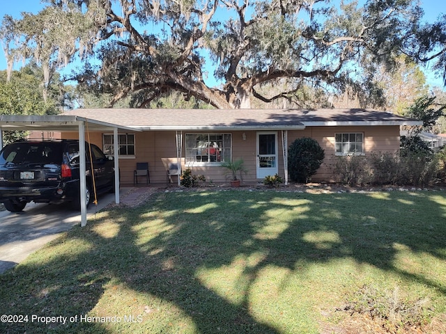 ranch-style home featuring a front yard and a carport