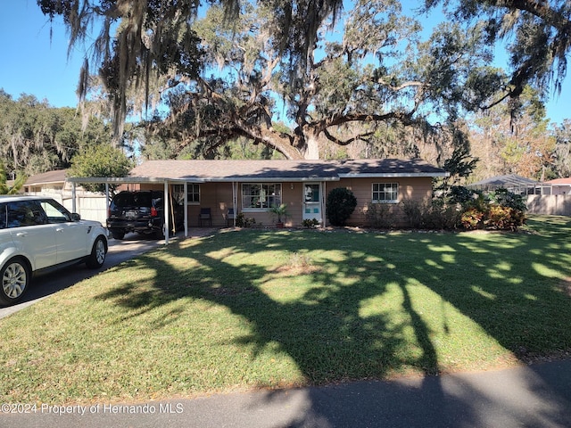 single story home featuring a front yard and a carport