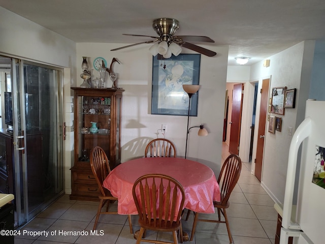 tiled dining room featuring ceiling fan