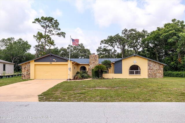 single story home with a front lawn and a garage