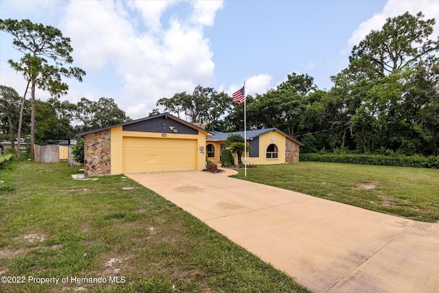 single story home featuring a garage and a front lawn