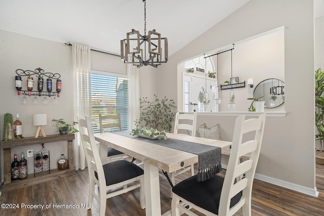 dining space featuring lofted ceiling, an inviting chandelier, and dark wood-type flooring