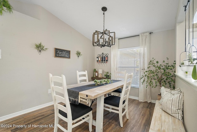 dining space with a chandelier, dark wood-type flooring, and vaulted ceiling