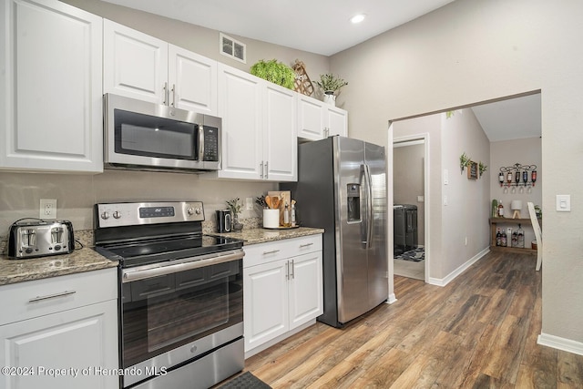 kitchen featuring white cabinets, light hardwood / wood-style floors, light stone counters, and appliances with stainless steel finishes