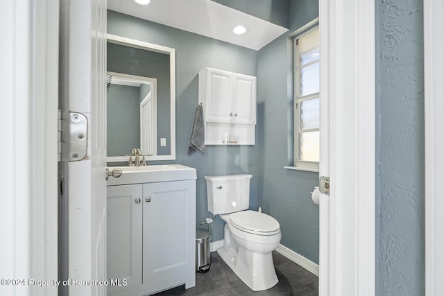 bathroom featuring tile patterned floors, vanity, and toilet