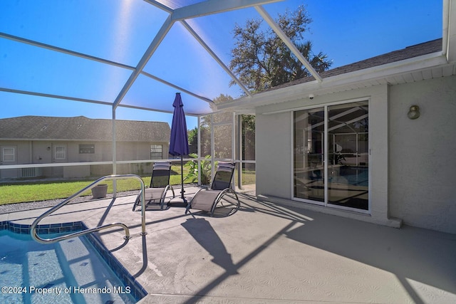 view of patio with glass enclosure