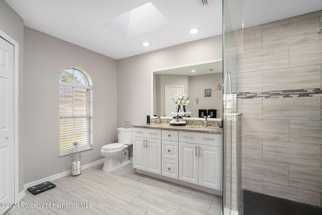 bathroom with a skylight, plenty of natural light, a shower with shower door, and toilet