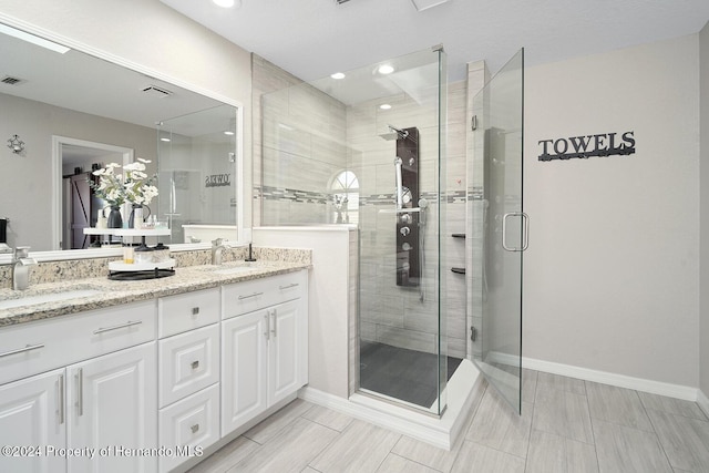 bathroom featuring vanity and an enclosed shower