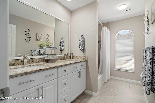 bathroom featuring vanity and shower / bath combo with shower curtain