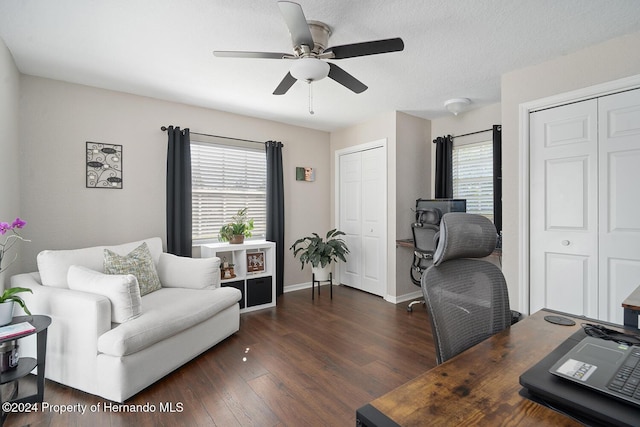 office space with ceiling fan, dark hardwood / wood-style flooring, and a textured ceiling