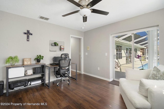 home office with dark hardwood / wood-style floors and ceiling fan