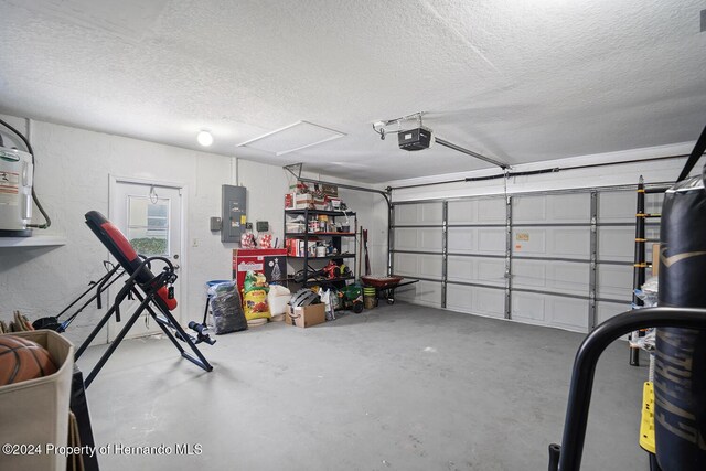 garage featuring electric panel and a garage door opener