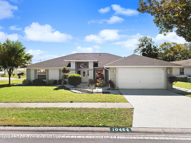 view of front of home featuring a front yard and a garage