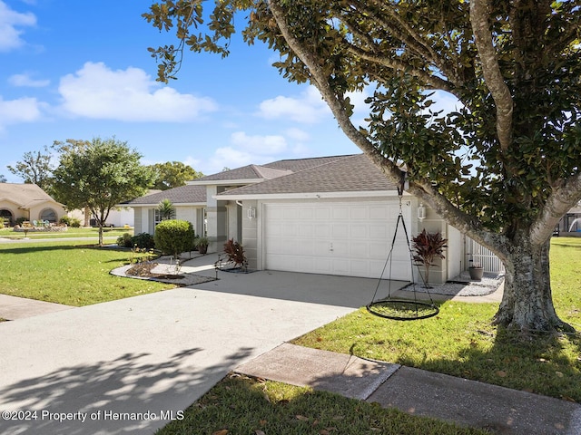 view of front of home with a front lawn and a garage