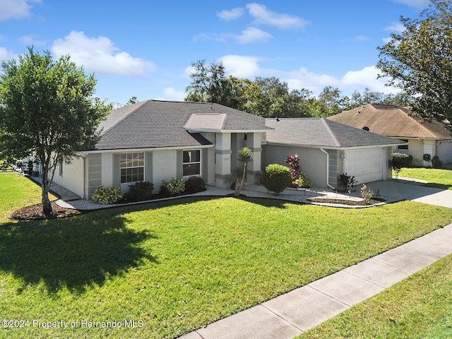 ranch-style house with a garage and a front lawn