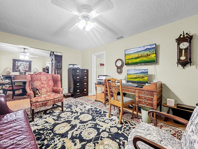 office space with ceiling fan and a textured ceiling