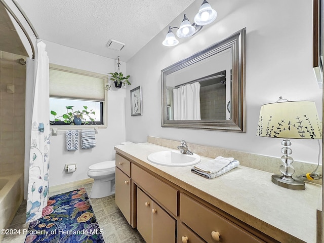 full bathroom with vanity, shower / bath combination with curtain, a textured ceiling, and toilet