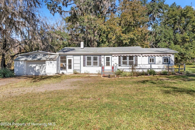 single story home with a front lawn and a garage