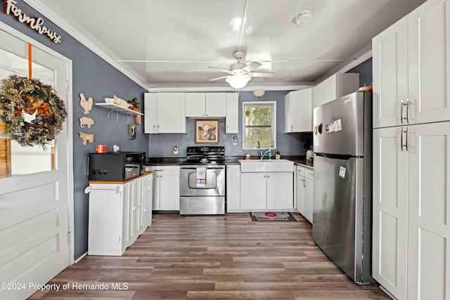 kitchen featuring appliances with stainless steel finishes, ceiling fan, sink, dark hardwood / wood-style floors, and white cabinetry