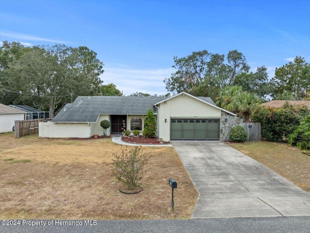 ranch-style house featuring a front lawn and a garage