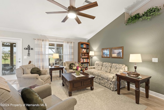 living room with light wood-type flooring, plenty of natural light, crown molding, and ceiling fan