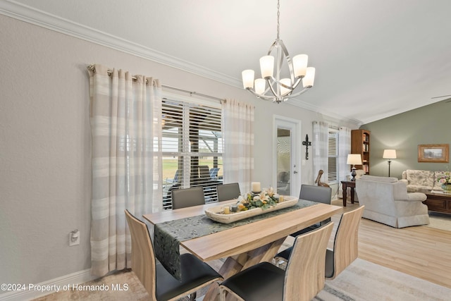 dining room featuring a chandelier, light hardwood / wood-style floors, and ornamental molding