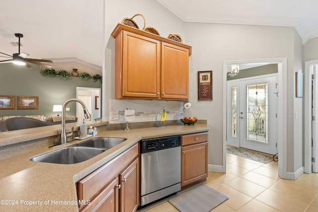 kitchen with crown molding, stainless steel dishwasher, lofted ceiling, and sink