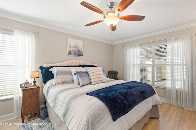 bedroom featuring ceiling fan, ornamental molding, and light wood-type flooring