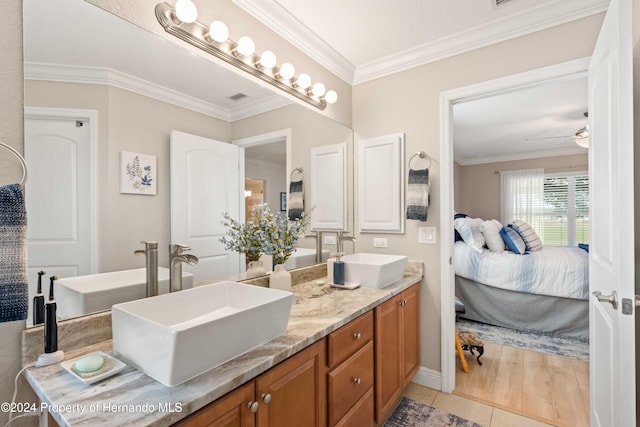 bathroom featuring ceiling fan, tile patterned flooring, vanity, and ornamental molding