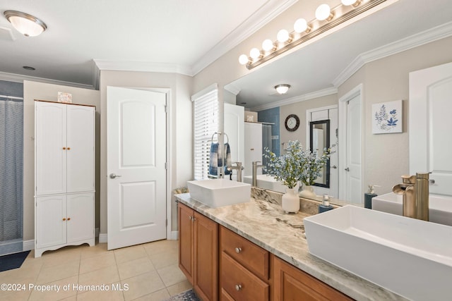 bathroom with vanity, crown molding, tile patterned flooring, and a shower