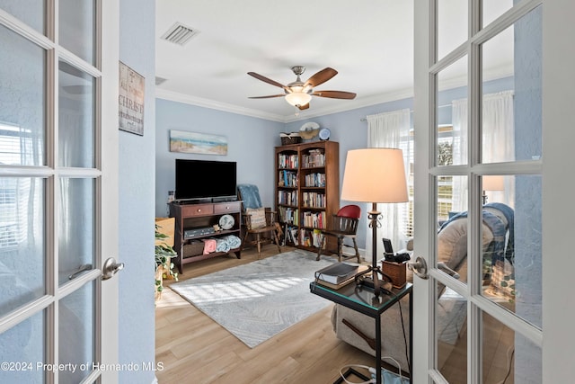 interior space featuring french doors, ceiling fan, ornamental molding, and hardwood / wood-style floors