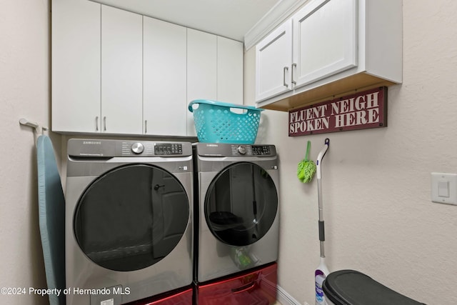 laundry room featuring cabinets and separate washer and dryer