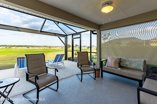 view of patio with outdoor lounge area and glass enclosure