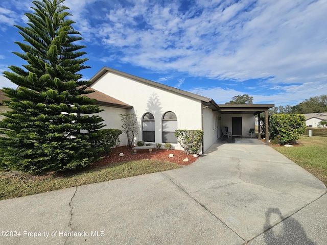 view of front of property featuring a carport