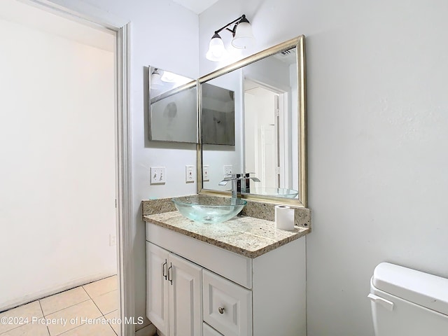 bathroom featuring tile patterned floors, vanity, and toilet