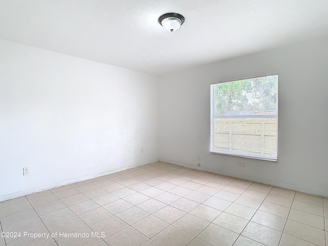 empty room featuring light tile patterned floors